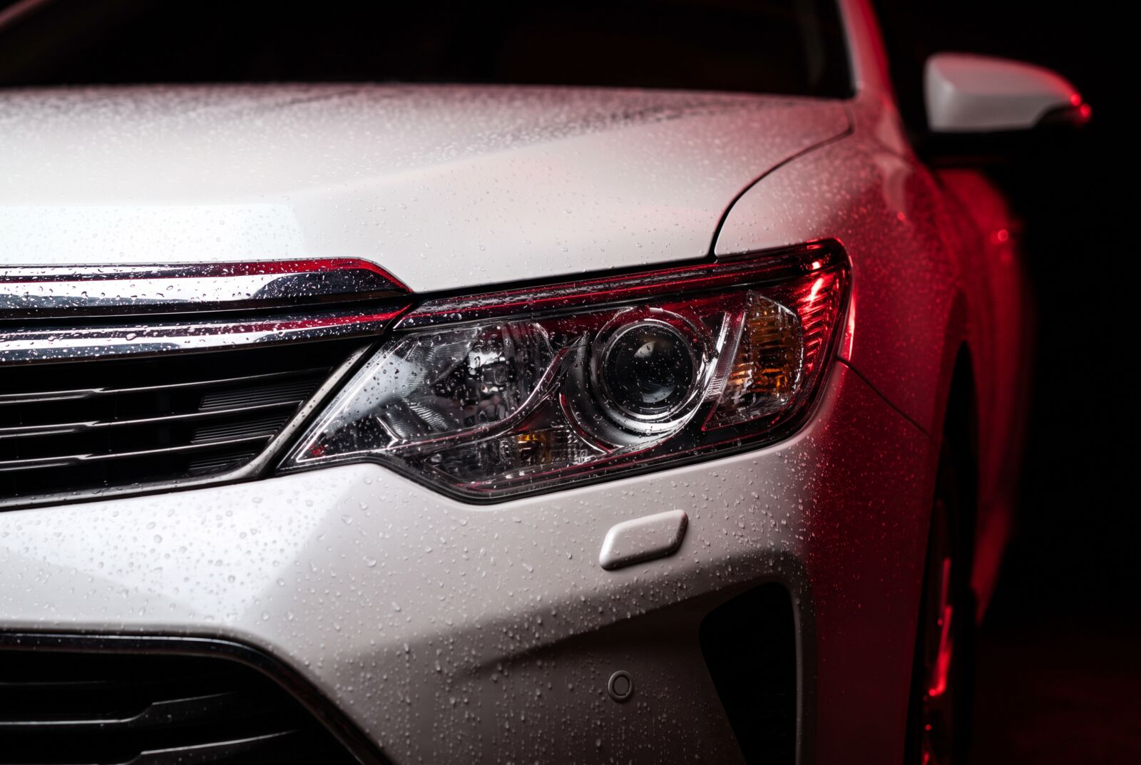 Headlight and grille detail of a freshly detailed Fly Wheels sedan