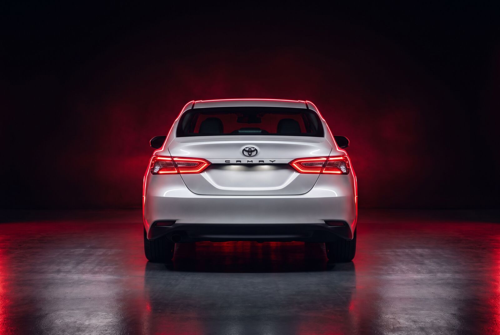 White Toyota Camry rear view with LED tail lights — car lift Dubai to Abu Dhabi